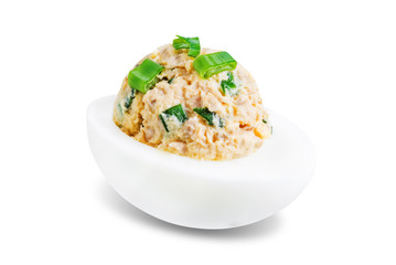 Canned Tuna deviled eggs with scallion on a white isolated background