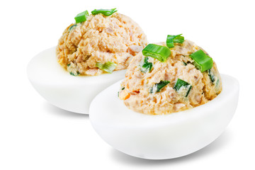 Canned Tuna deviled eggs with scallion on a white isolated background