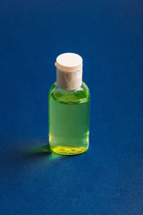 Alcohol gel to protect hands from infection on a blue background with place for text