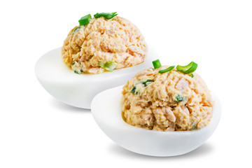 Canned Tuna deviled eggs with scallion on a white isolated background