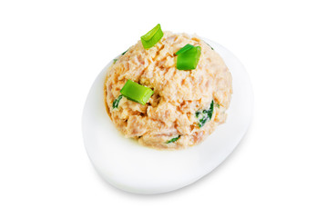 Canned Tuna deviled eggs with scallion on a white isolated background