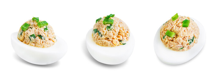 Canned Tuna deviled eggs with scallion on a white isolated background