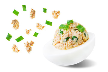 Canned Tuna deviled eggs with scallion on a white isolated background