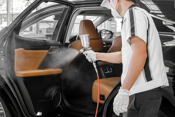 worker character in protective mask  sprays and clean bacterial or virus in a car.