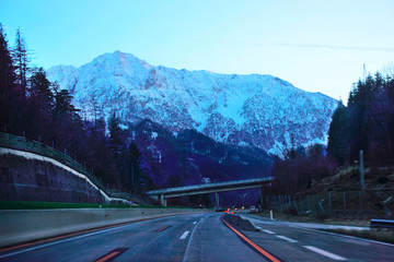 Road with twilight view on Alpine mountains in Austria