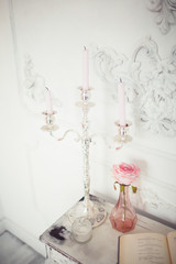 Many candles with candlesticks on the home background. Home and home decor.