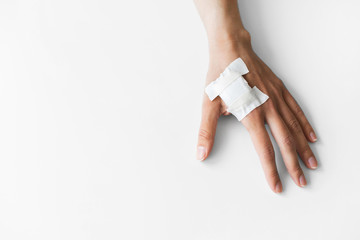 Woman hand with plaster bandage after mandatory medical chipization in Sweden. Implantation of microchip in hand. Health control of citizens.