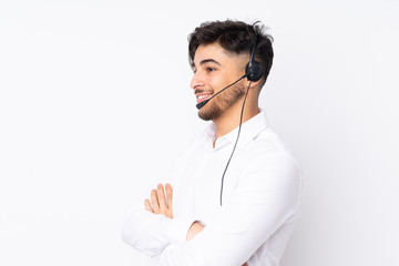 Telemarketer Arabian man working with a headset isolated on white background