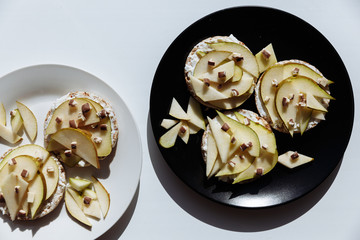 Delicious tartlets or cake with mixed pieces of apples and pears and chocolate from above. Summer pastry desserts