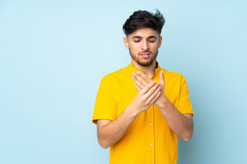 Arabian handsome man over isolated background suffering from pain in hands