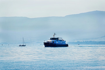Excursion ferry with Swiss flag on Lake Geneva in Lausanne