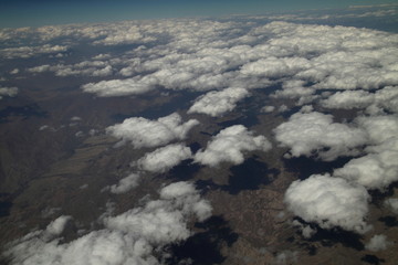 Naklejka premium View of the rocks from the plane. Beautiful peaks view. Insiration by clouds. Scenic top environment. Wallpaper and background.