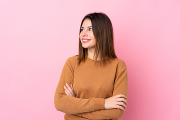 Obraz premium Young woman over isolated pink background happy and smiling