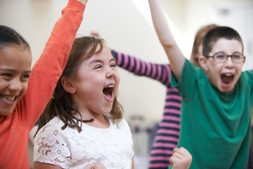 Group Of Excited Children At Stage School Enjoying Dance Class Together