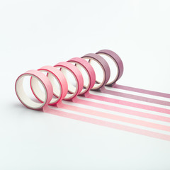 Adhesive tape rolls and parallel strips on white background