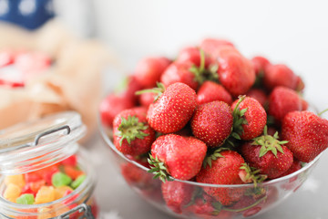 Red strawberries in a transparent plate on the table.Red strawberries in a transparent plate on the table.