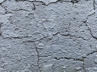 old cracked concrete wall. Grey old wall as background. blue paint on the wall. old wall texture design.