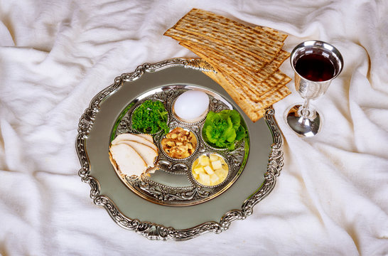 Matzoh jewish holiday bread Jewish family celebrating passover with traditional seder plate