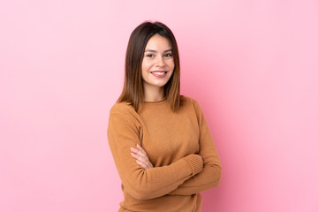 Fototapeta premium Young woman over isolated pink background with arms crossed and looking forward