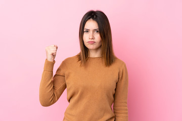 Young woman over isolated pink background with angry gesture