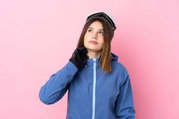 Young skier woman over isolated pink background thinking an idea