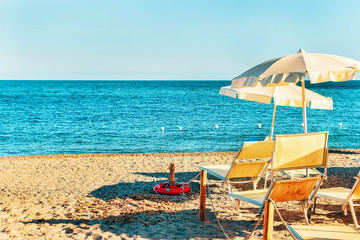 Fototapeta na wymiar Sun umbrellas Chia Beach at Mediterranean Sea South Sardinia Italy