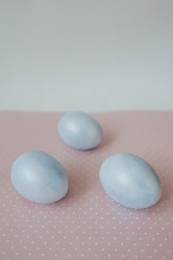 blue painted easter eggs on a pink background, pastel colors