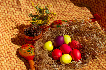 Painted Easter eggs in a nest of straw. Sunlight. Easter still life. - 336483317
