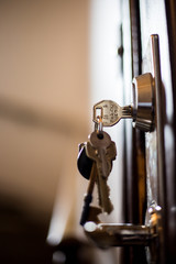 close up of a door handle with key