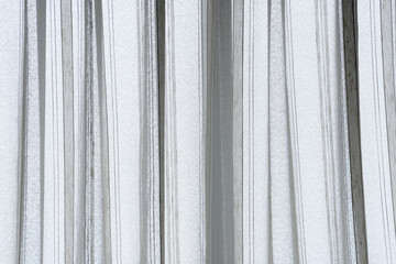white curtain wavy with a pattern background. transparent curtain on window