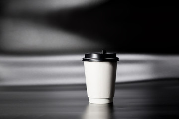 One Takeaway paper cup on black background