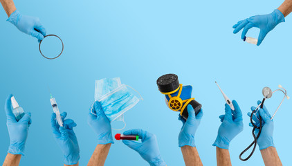 many hands holding medical tools on blue