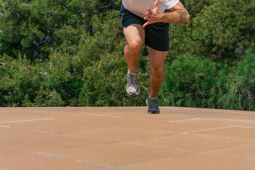 Morning running session at rooftop. Workout during quarantine sprint. Young man's body.