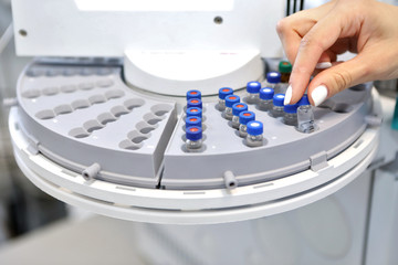 Quality Control Laboratory medicine. Chromatograph operation. A woman makes an analysis on a gas chromatograph. Development of a new vaccine against the covid-19 virus.