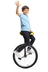 Boy sitting on a unicycle and waving © Ljupco Smokovski