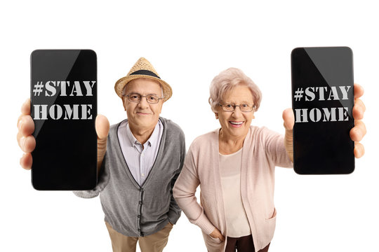 Seniors holding phones with messages saying stay home due to covid-19 pandemic