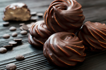 chocolate covered marshmallow on black background