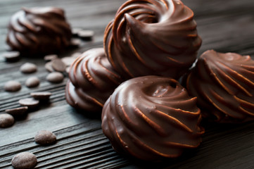 chocolate covered marshmallow on black background