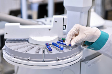 Quality Control Laboratory medicine. Chromatograph operation. A woman makes an analysis on a gas chromatograph. Development of a new vaccine against the covid-19 virus.