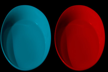 Two bowls with water of different colors,