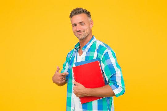 College university education. Man adult student. Final exam and graduation. Dedicated to studying. Student with textbooks. Regular student carry workbooks. Student life. Keep learning all life