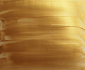 Abstract gold (bronze) glittering color surface. Paint smear brush stroke stain texture.