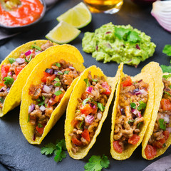 Taco shell nachos with beef, guacamole, chili, cheese salsa, tequila