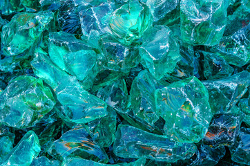 Glass decorative stones, chipped glass for garden decor, landscape design. Shiny stones background