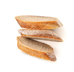 Freshly baked bread isolated on a white background. Crumbs and Bread slice close up. Top view.