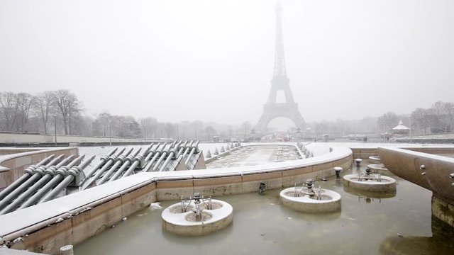 Eiffel Tower in winter with snow in Paris France, seen from the Place du Trocadero, on a snowy day