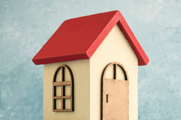 wooden carved house over blue background with copy space