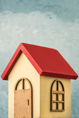 wooden carved house over blue background with copy space