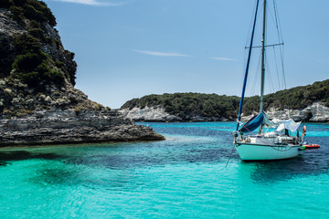Anchored sailboat in a calm bay in summer day/vacation, Mediterranean, Bonifacio, Corsica, France,...