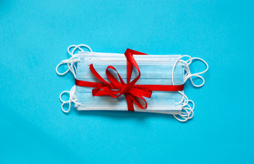 Medical antiviral mask on a blue background. Coronavirus protection. A gift for fighting viruses.